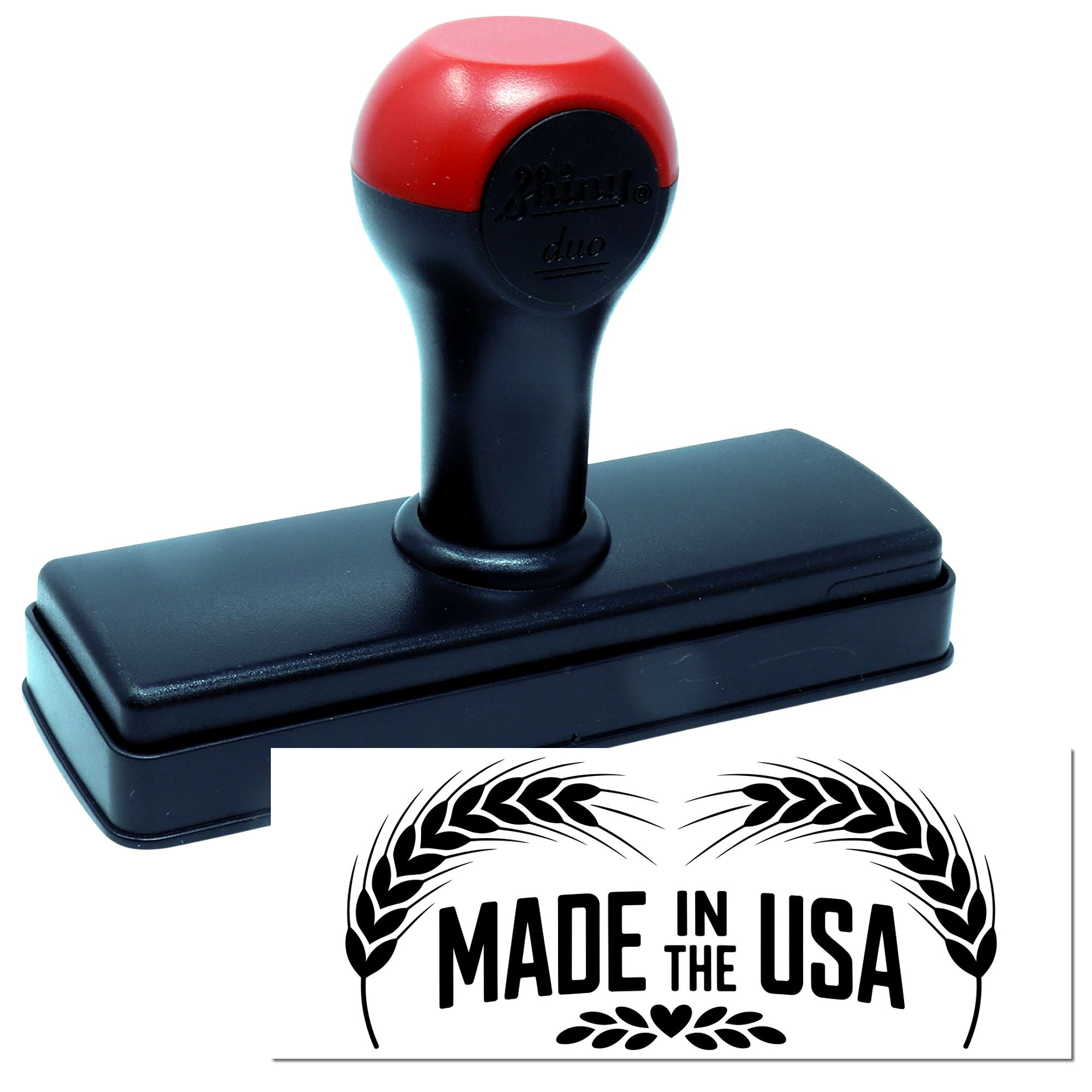 Red-and-black self-inking stamp with black base, showing a Made in the USA seal design with wheat wreath.