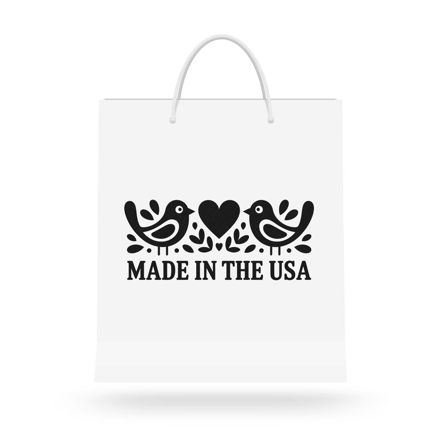 White tote bag with black stamp-style seal, birds and heart, reading Made in the USA.