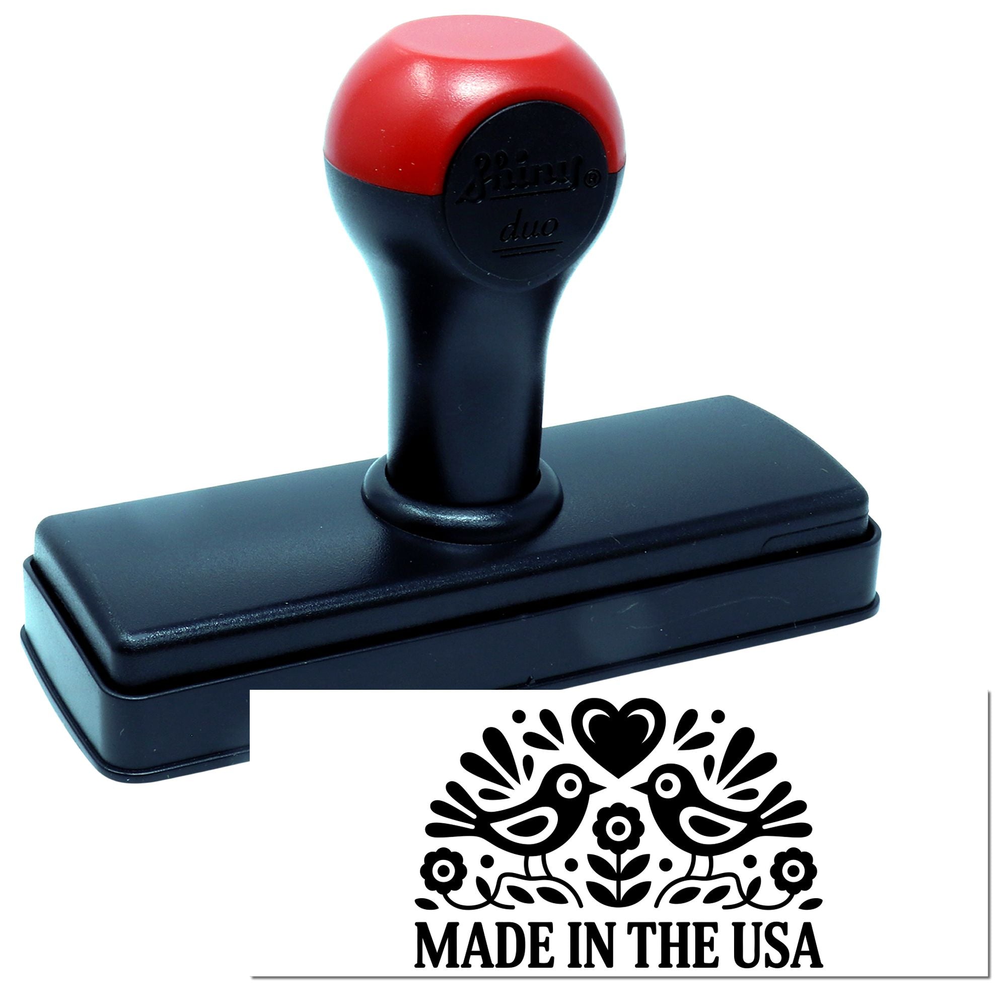 Red-and-black self-inking stamp with rectangular base and a Made in the USA decorative seal design.