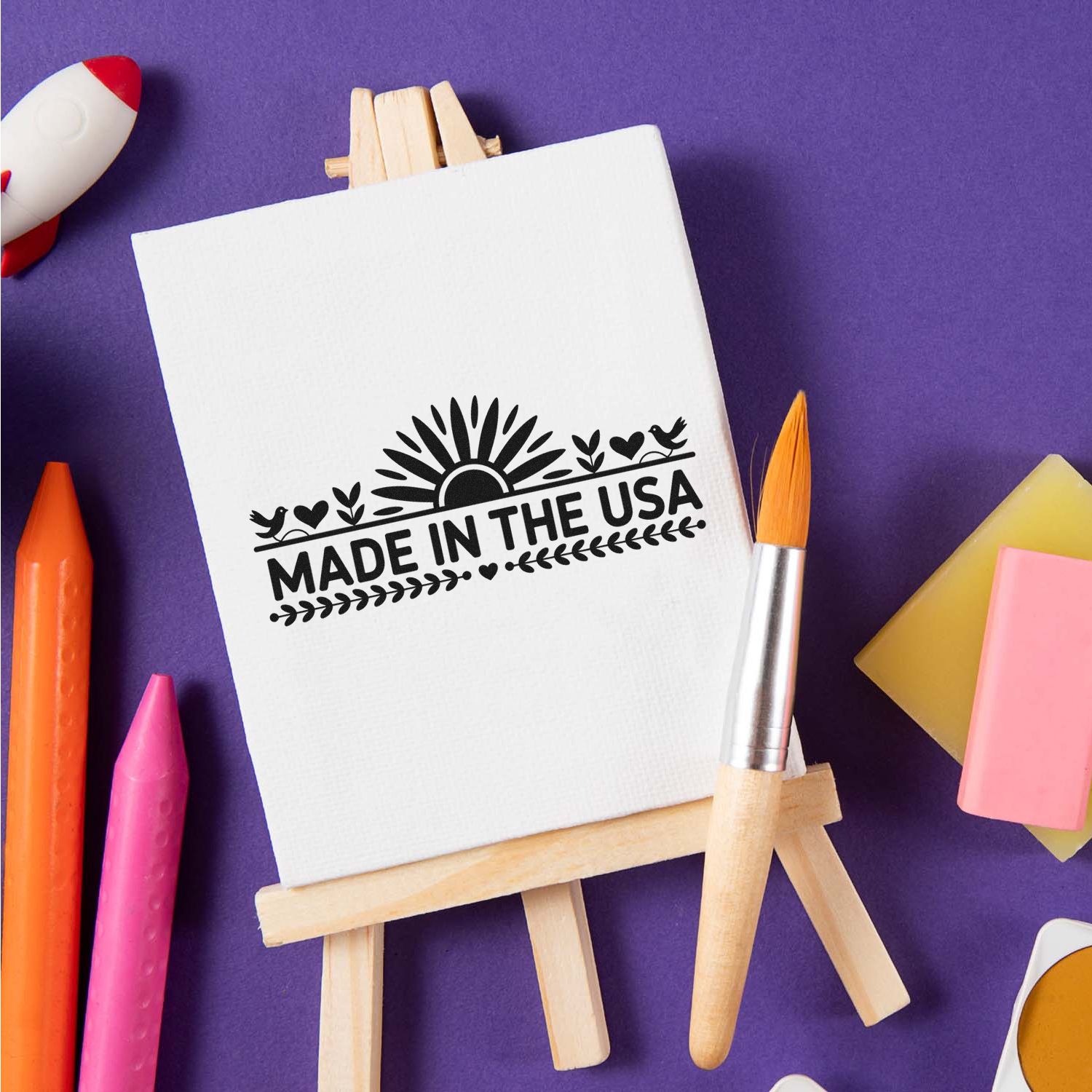 Made in the USA stamp on white canvas easel, purple background, with colorful wax seals and craft tools.