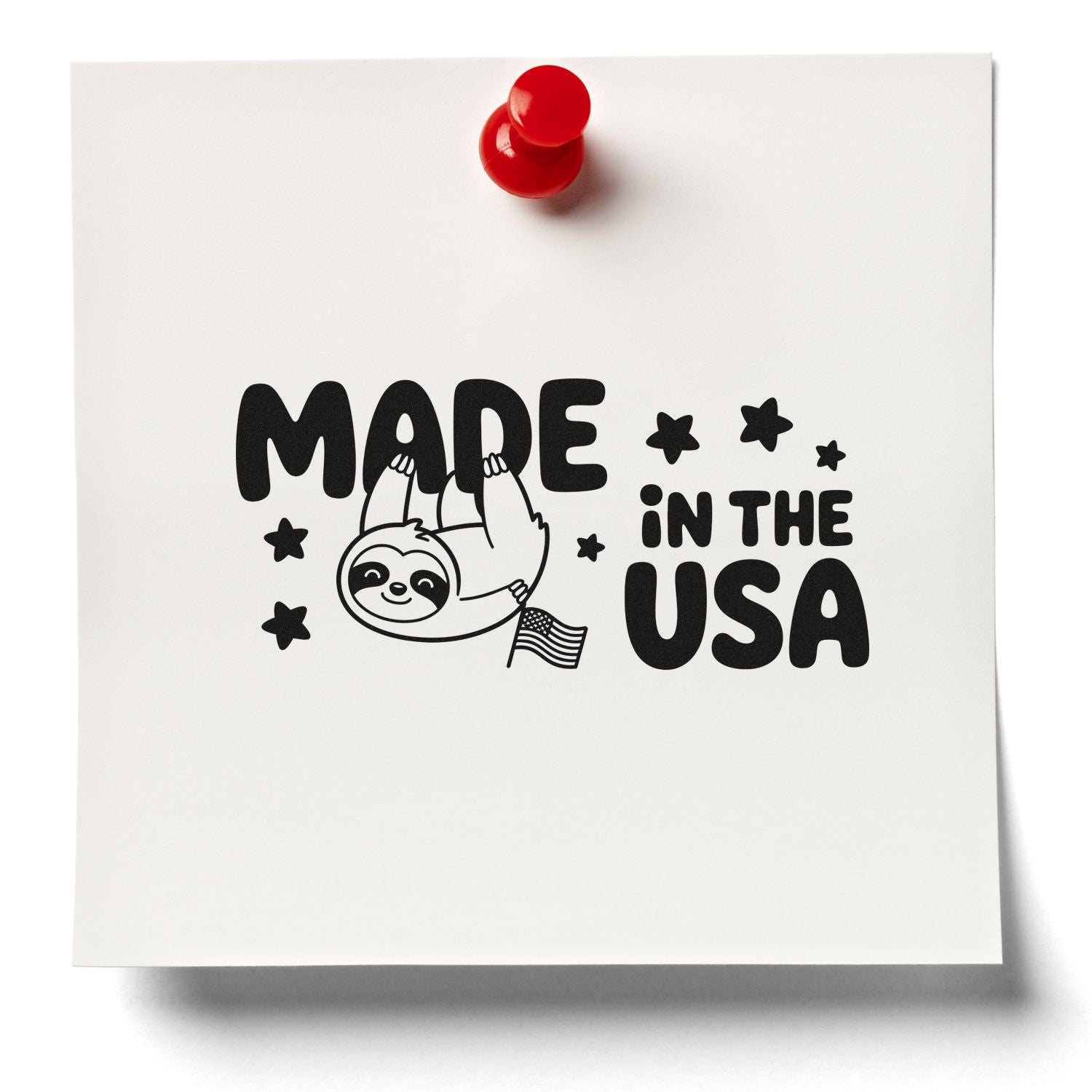 Black Made in the USA stamp seal design with a sloth, stars, and U.S. flag on white paper, held by a red pushpin.