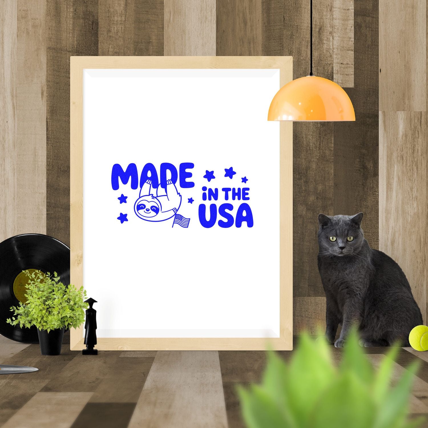 Blue Made in the USA sloth stamp and seal design on white framed sample with stars and small U.S. flag.
