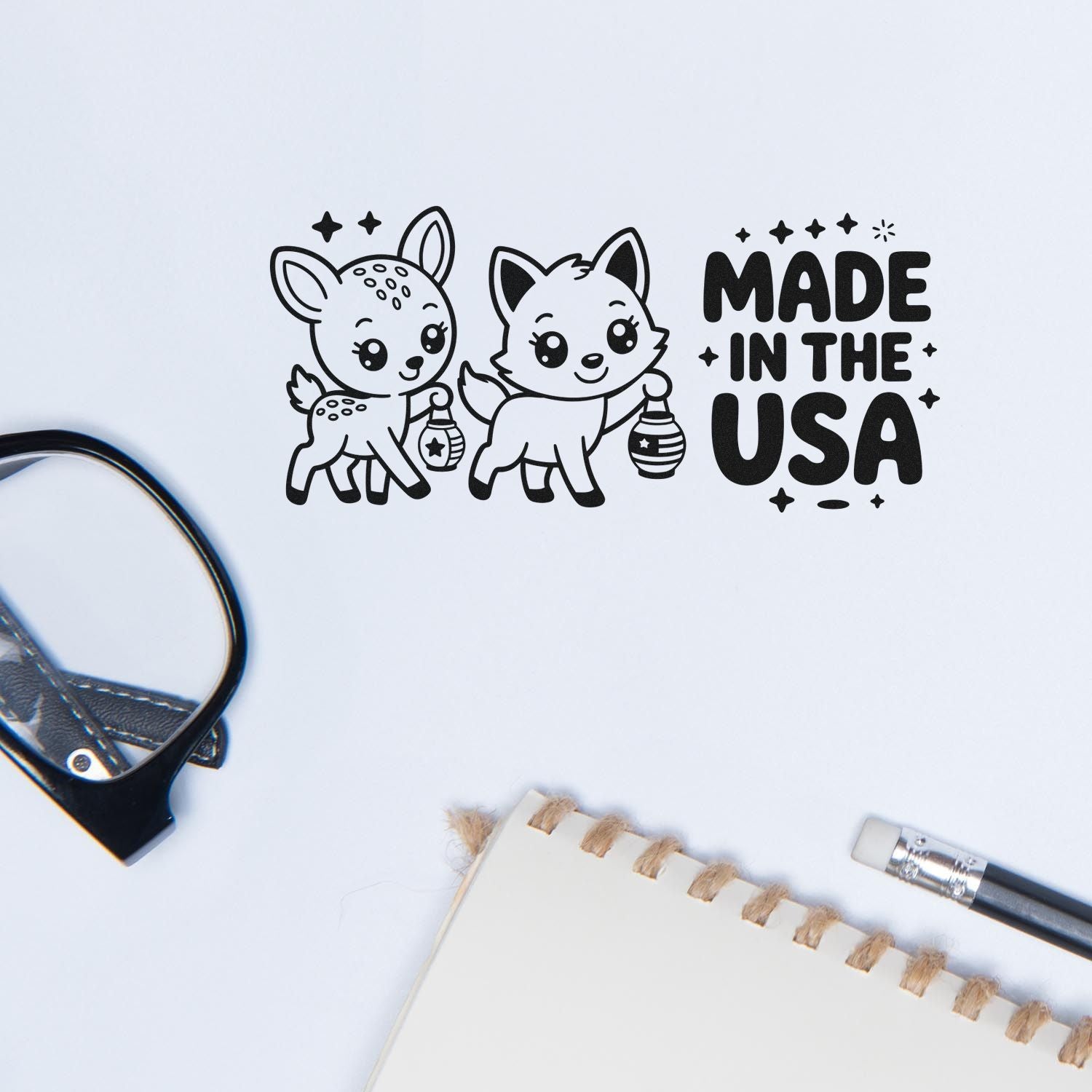 Black stamp and seal design with deer and fox holding lanterns, Made in the USA text on a white background.