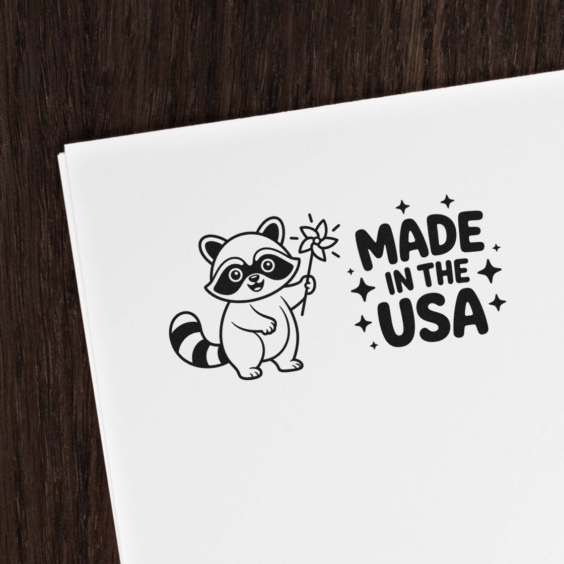 Black raccoon stamp and seal design on white paper with Made in the USA text and stars.