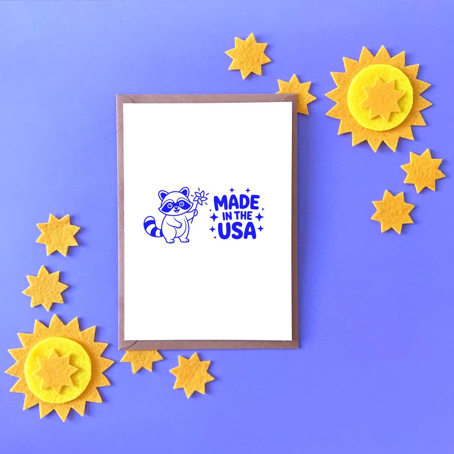 Blue Made in the USA stamp with raccoon, surrounded by yellow star seal stickers on a purple background.