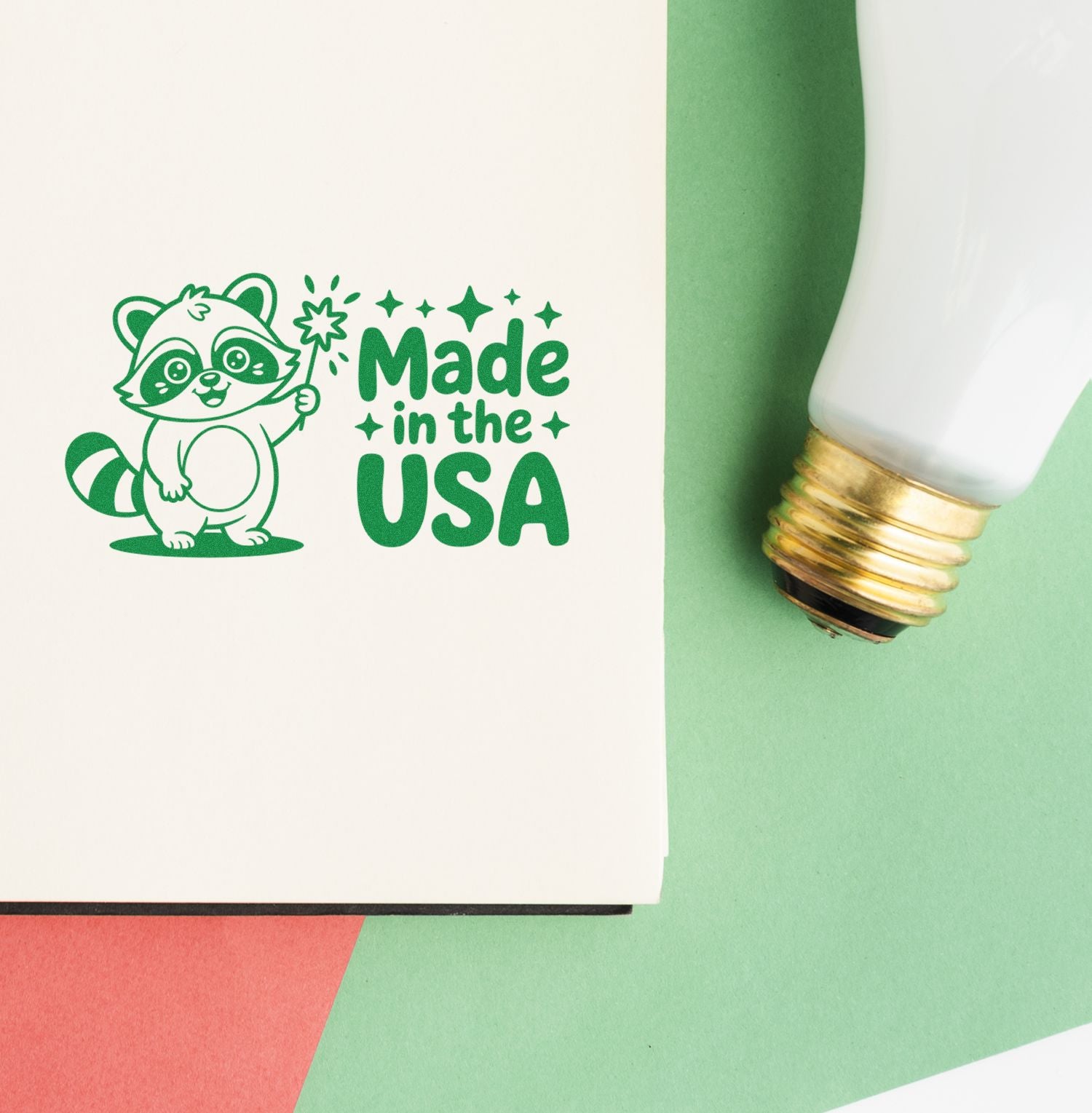 Green raccoon Made in the USA stamp beside a white-and-gold seal applicator on pastel green and red background