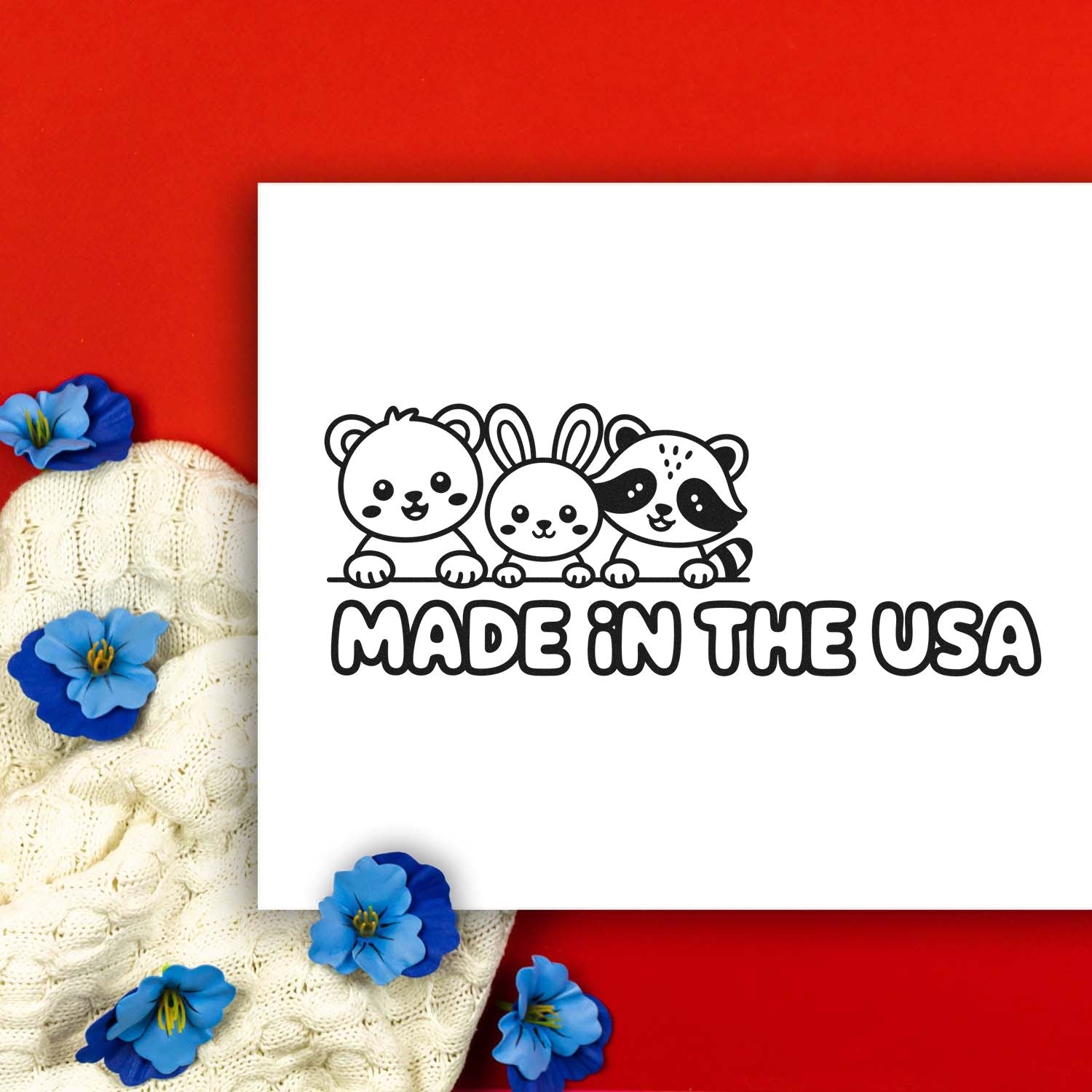 Black Made in the USA stamp and seal with three cute animals on white, against a red background with blue flowers.