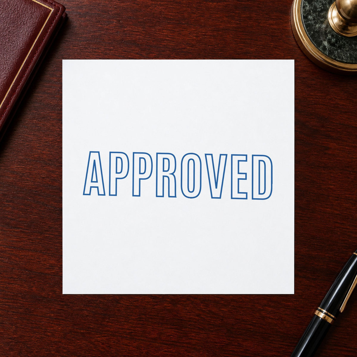 "Approved" Xstamper stamp in use on paper, 1/2 x 1-5/8 in rectangle imprint