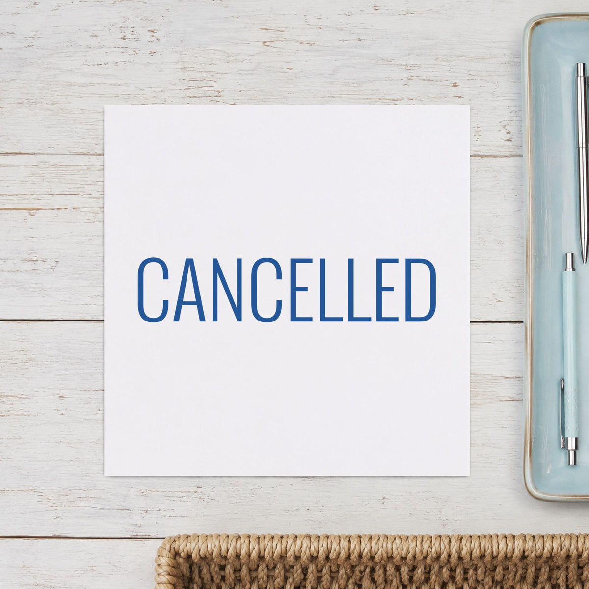 Pre-inked "Cancelled" stamp marking paperwork in an office setting