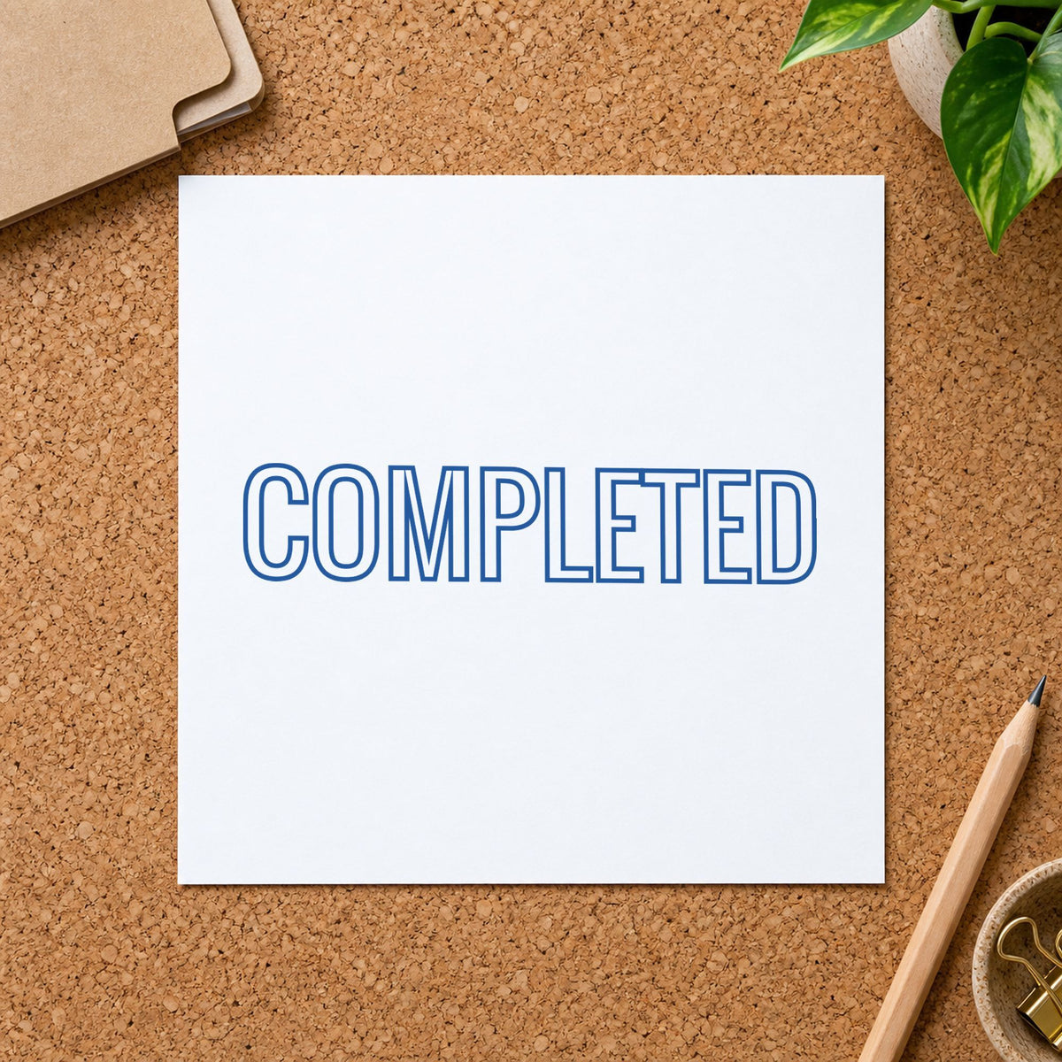 "Completed" Xstamper stamp in use on paper, Approximately 1/2 in tall x 1-5/8 in wide rectangle imprint