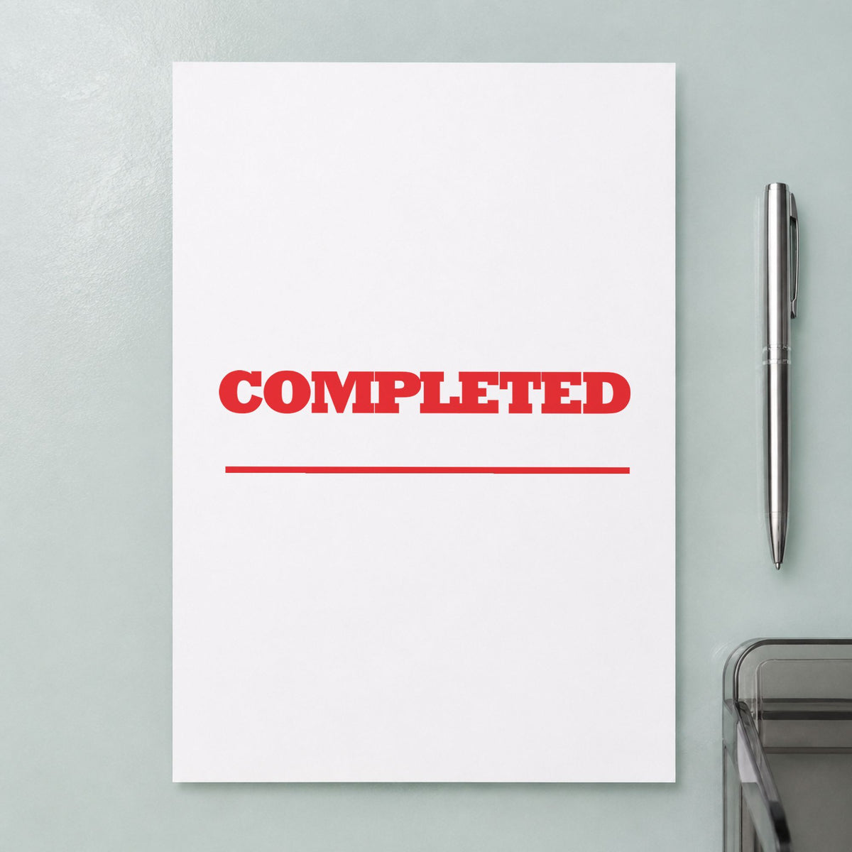"Completed" Xstamper stamp in use on paper, 1/2 x 1-5/8 in rectangle imprint