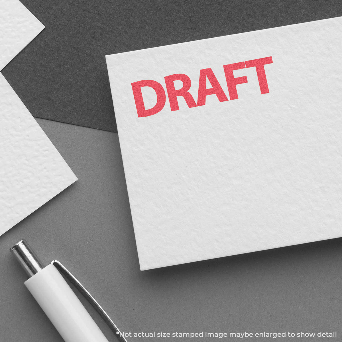 "Draft" pre-inked imprint on a page, rectangle shape at Approximately 1/2 in tall x 1-5/8 in wide