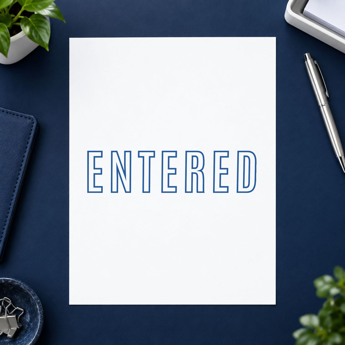 "Entered" stamp pressed on paper, no separate ink pad needed