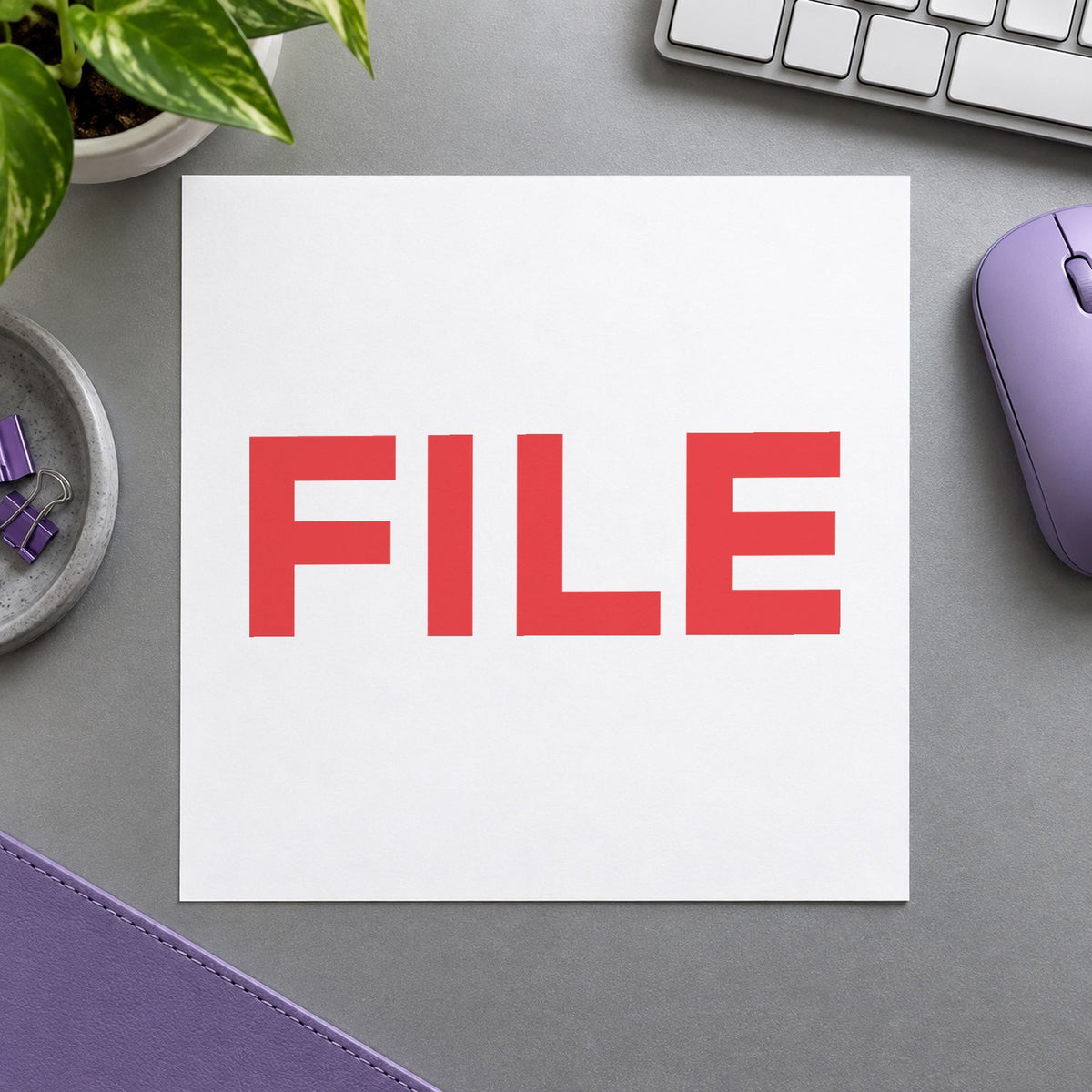 Pre-inked "File" stamp marking paperwork in an office setting