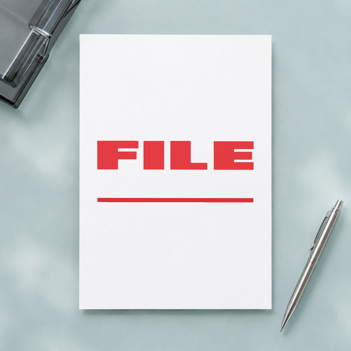 "File" Xstamper stamp in use on paper, Approximately 1/2 in tall x 1-5/8 in wide rectangle imprint