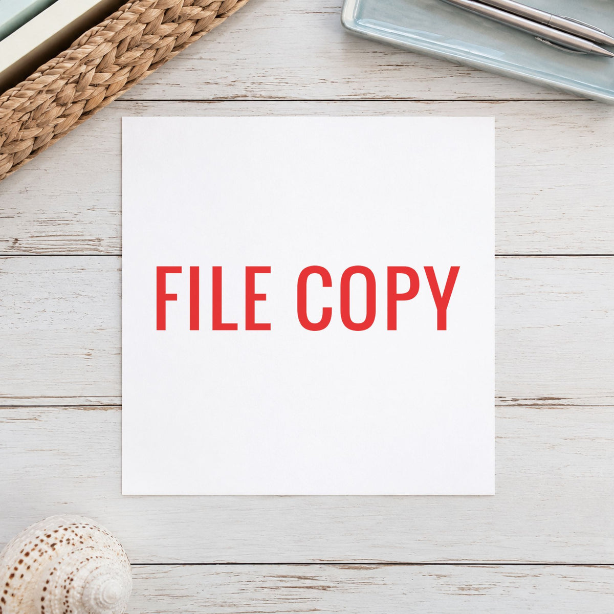 "File copy" Xstamper stamp in use on paper, 1/2 x 1-5/8 in rectangle imprint