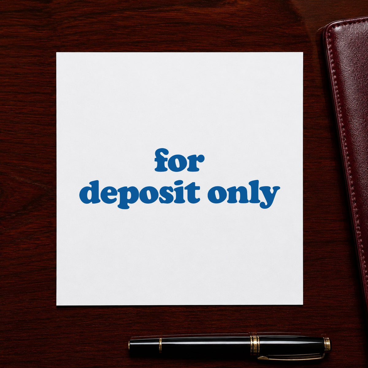 "For deposit only" Xstamper stamp in use on paper, 1/2 x 1-5/8 in rectangle imprint