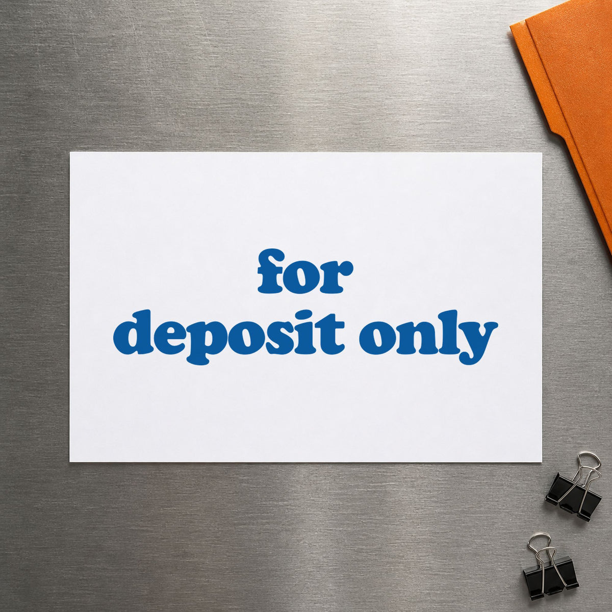 Pre-inked "For deposit only" stamp marking paperwork in an office setting