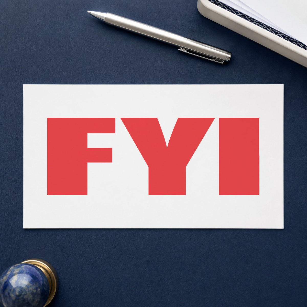 Pre-inked "FYI" stamp marking paperwork in an office setting