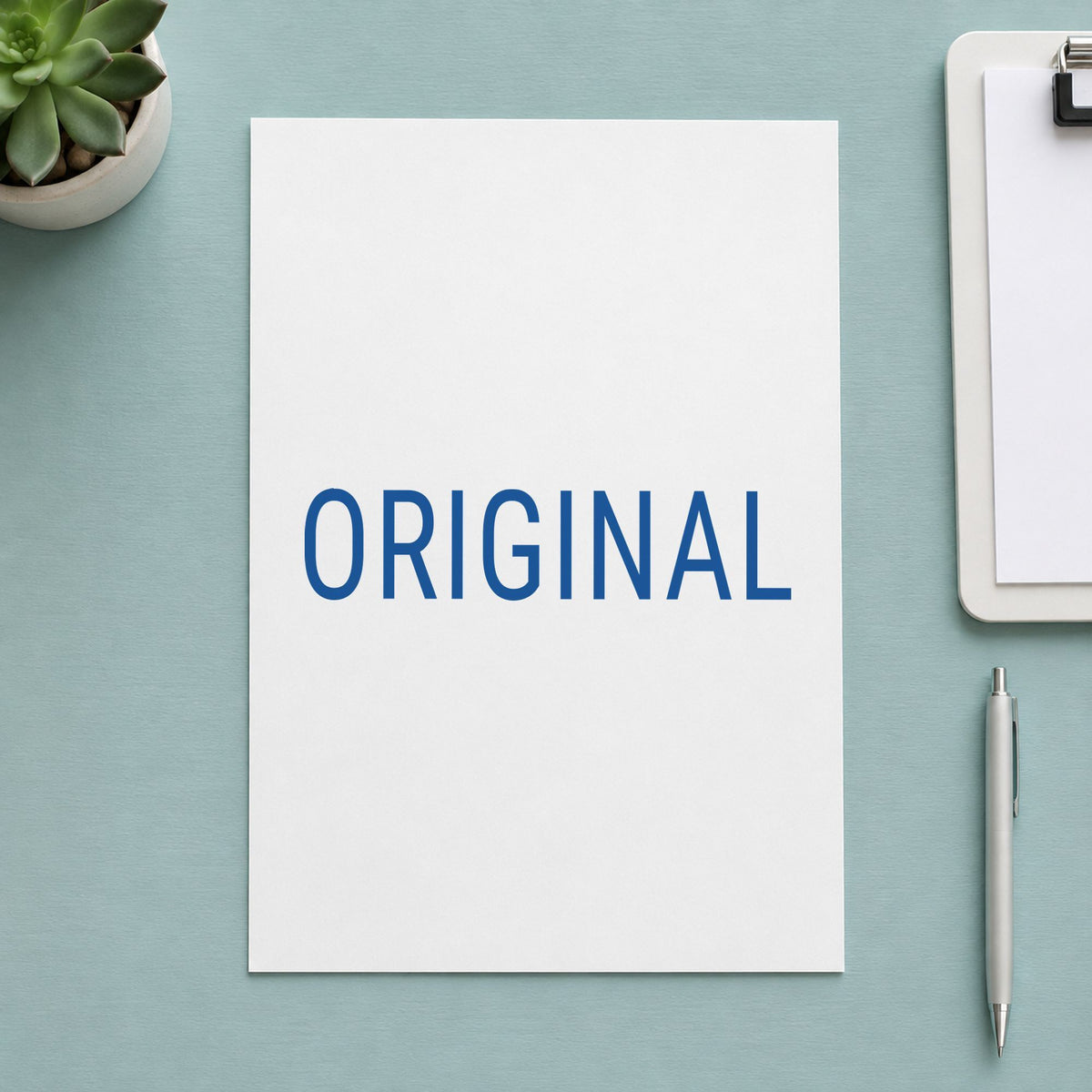 "Original" Xstamper stamp in use on paper, 1/2 x 1-5/8 in rectangle imprint