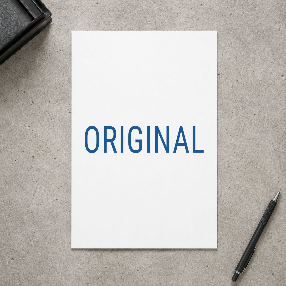 Pre-inked "Original" stamp marking paperwork in an office setting