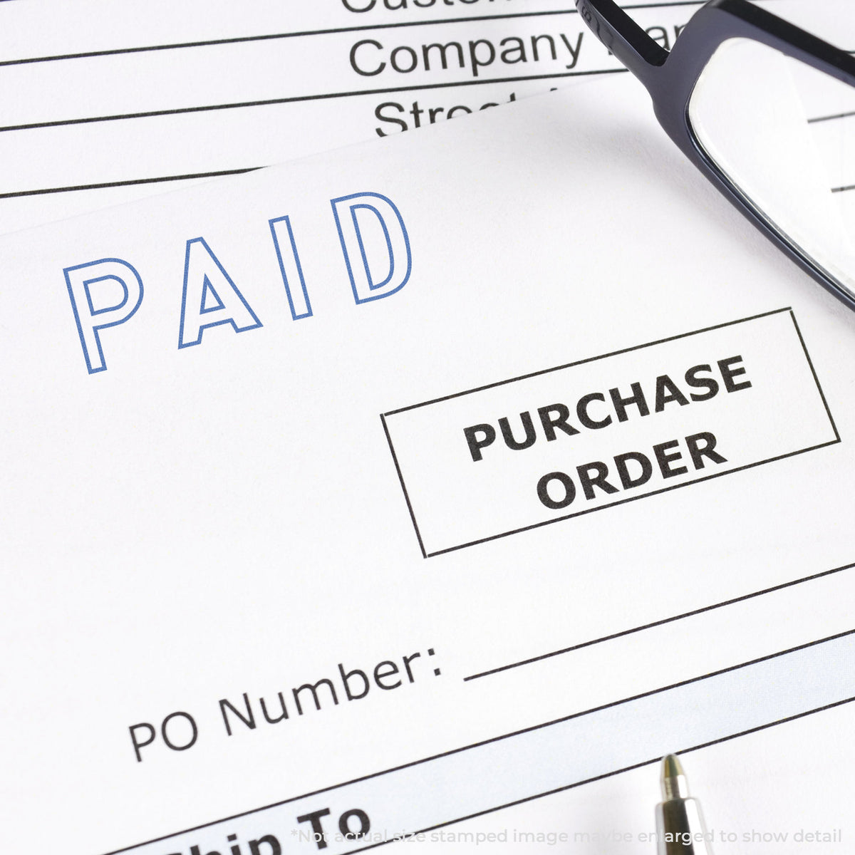 "Paid" pre-inked imprint on a page, rectangle shape at Approximately 1/2 in tall x 1-5/8 in wide