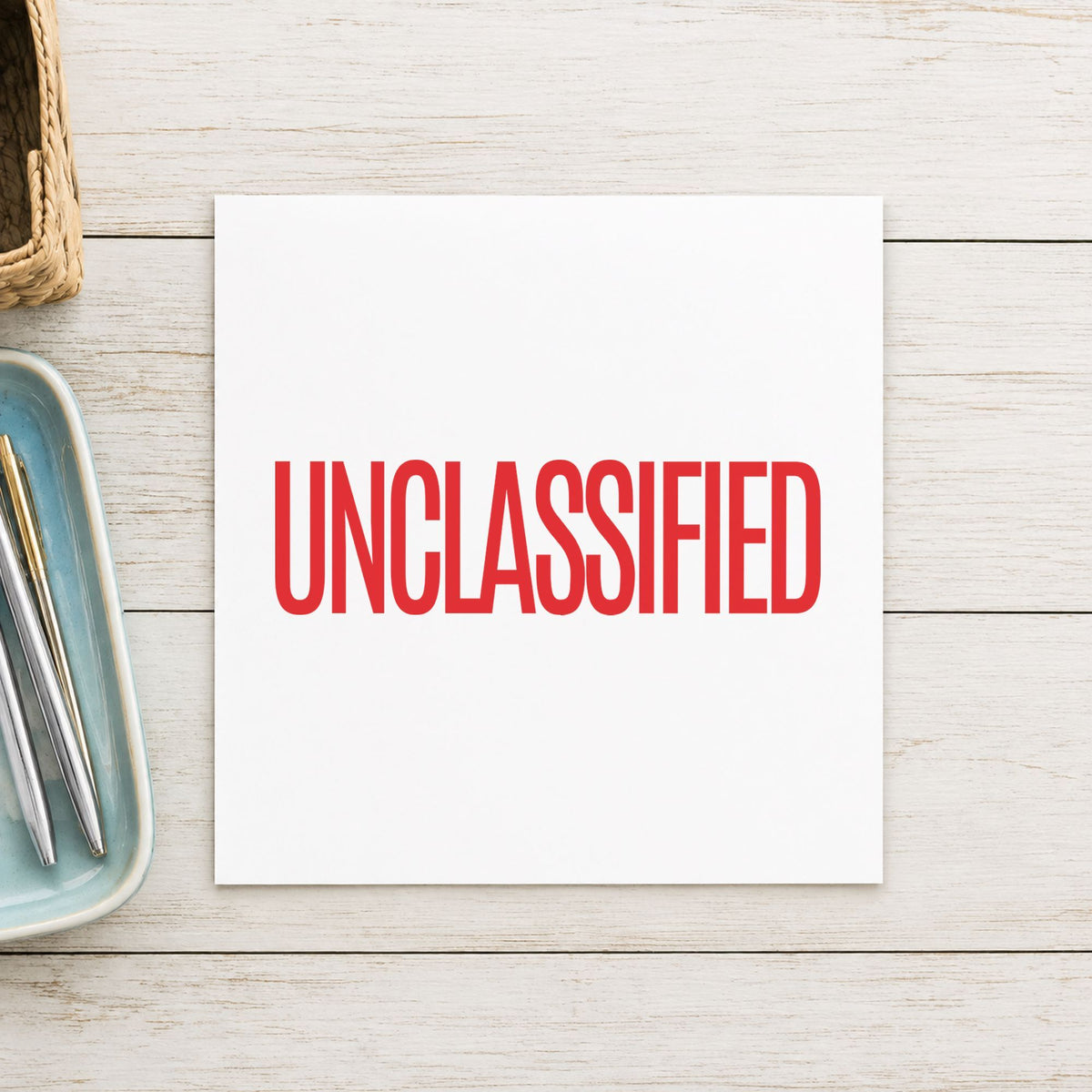 Pre-inked "Unclassified" stamp applied to a document, Approximately 1/2 in tall x 1-5/8 in wide impression