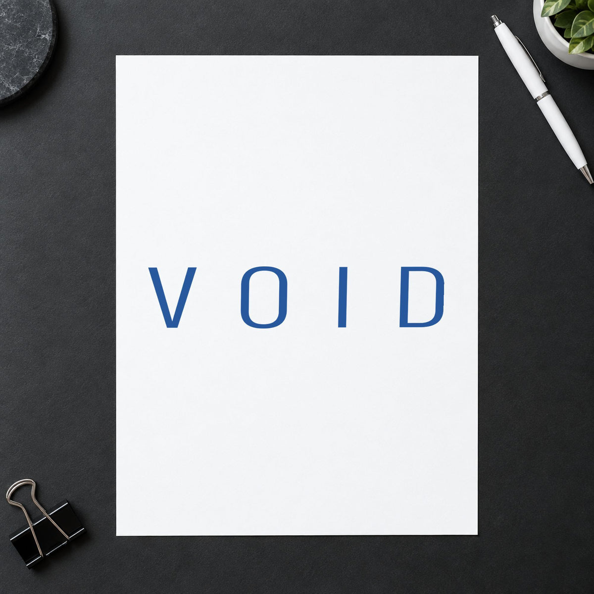 "Void" Xstamper stamp in use on paper, Approximately 1/2 in tall x 1-5/8 in wide rectangle imprint