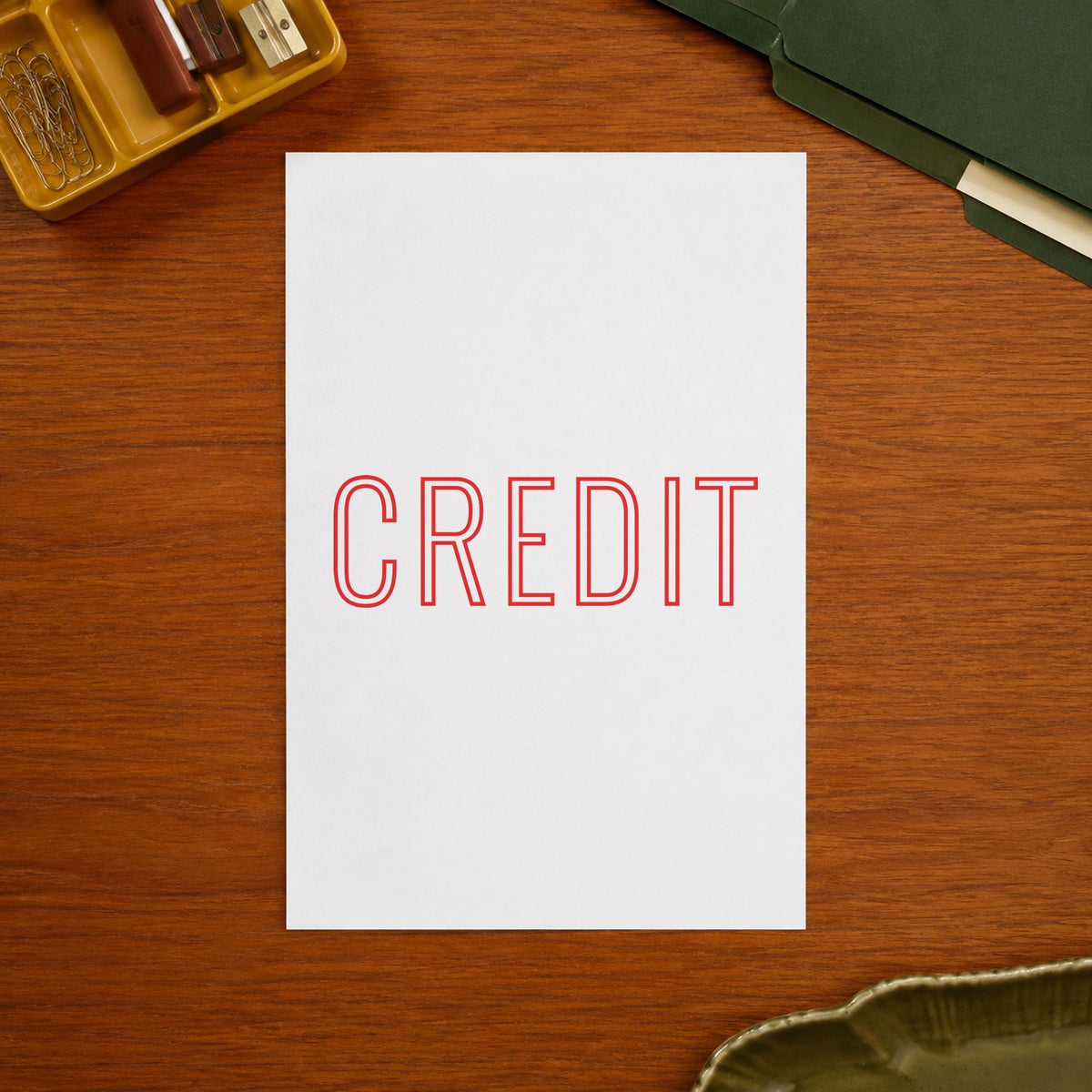 Pre-inked "Credit" stamp marking paperwork in an office setting