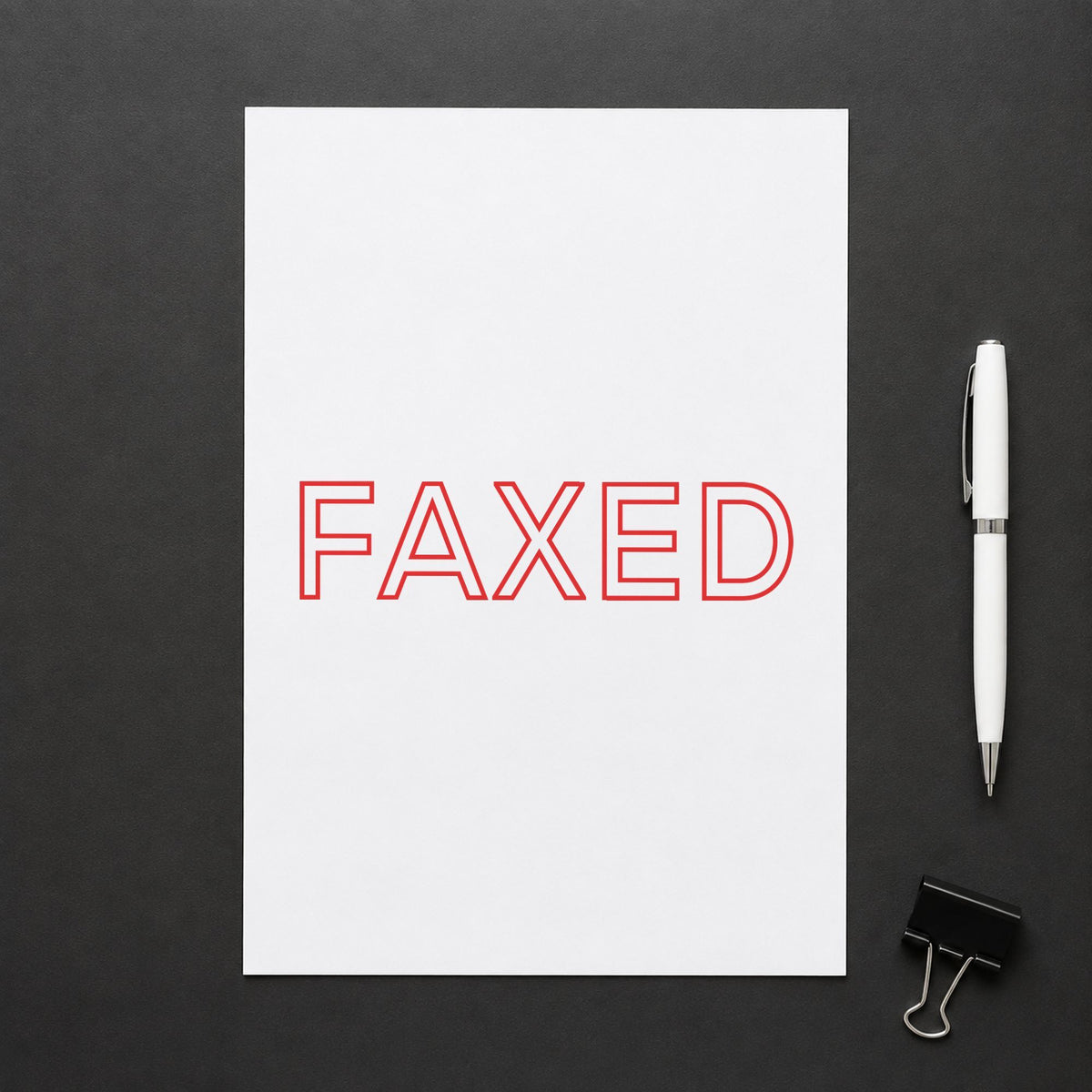 "Faxed" Xstamper stamp in use on paper, Approximately 1/2 in tall x 1-5/8 in wide rectangle imprint