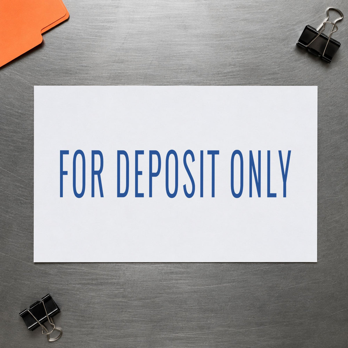 Pre-inked "For deposit only" stamp marking paperwork in an office setting