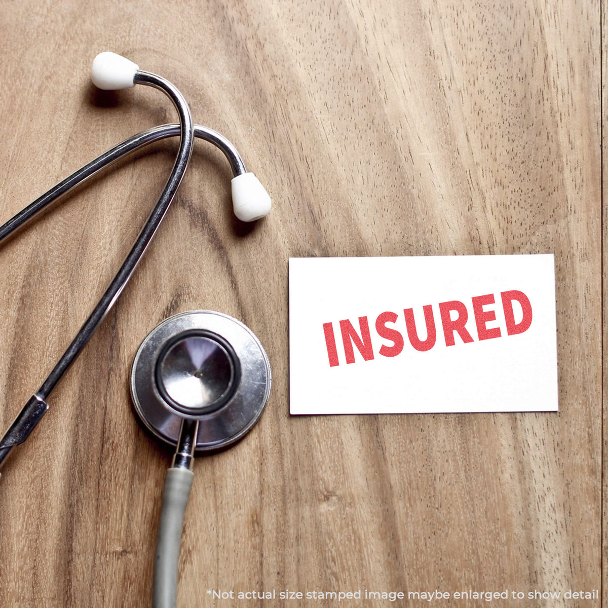 "Insured" pre-inked imprint on a page, rectangle shape at 1/2 x 1-5/8 in