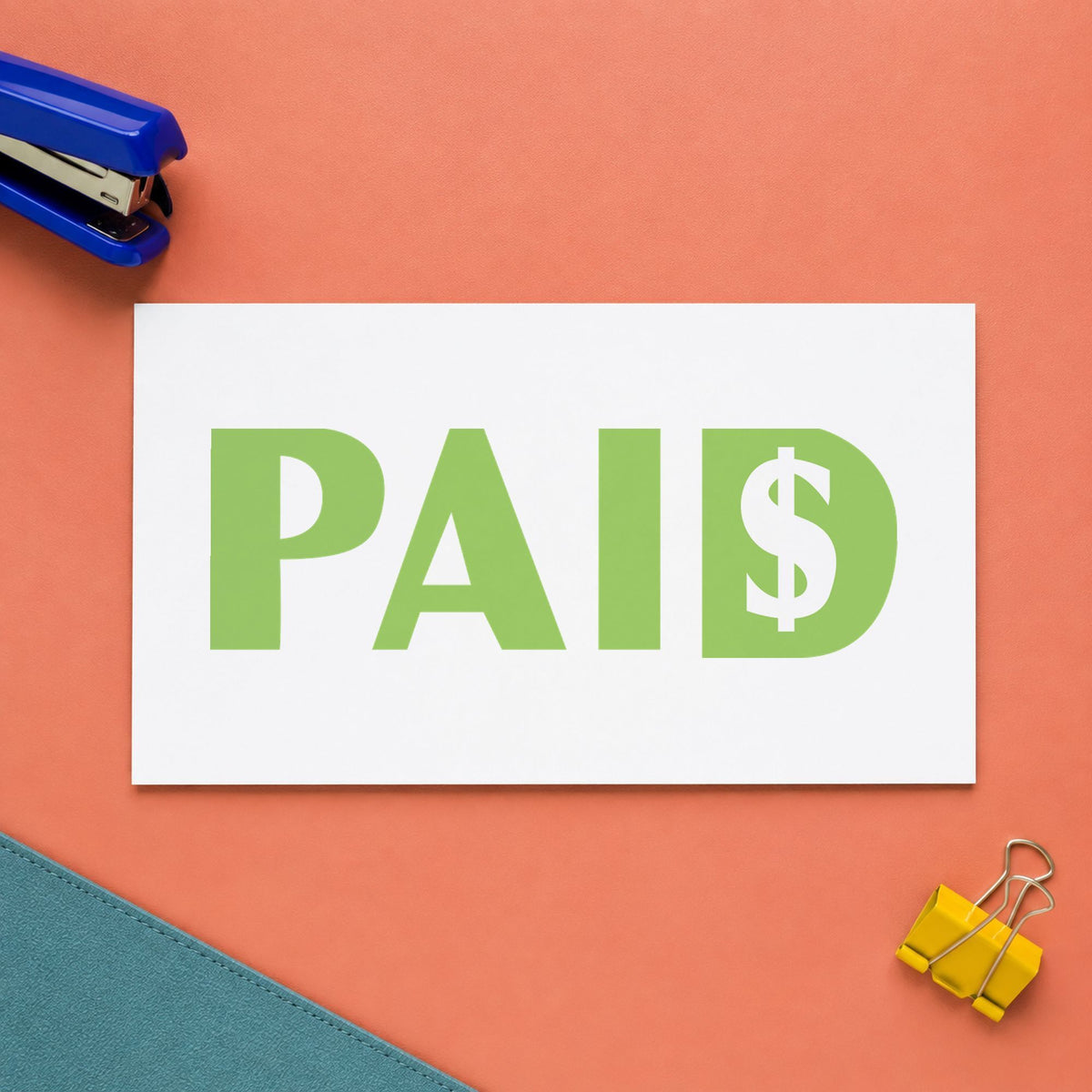 "Paid" Xstamper stamp in use on paper, 1/2 x 1-5/8 in rectangle imprint