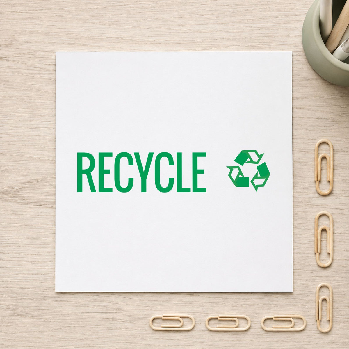 "Recycle" Xstamper stamp in use on paper, 1/2 x 1-5/8 in rectangle imprint
