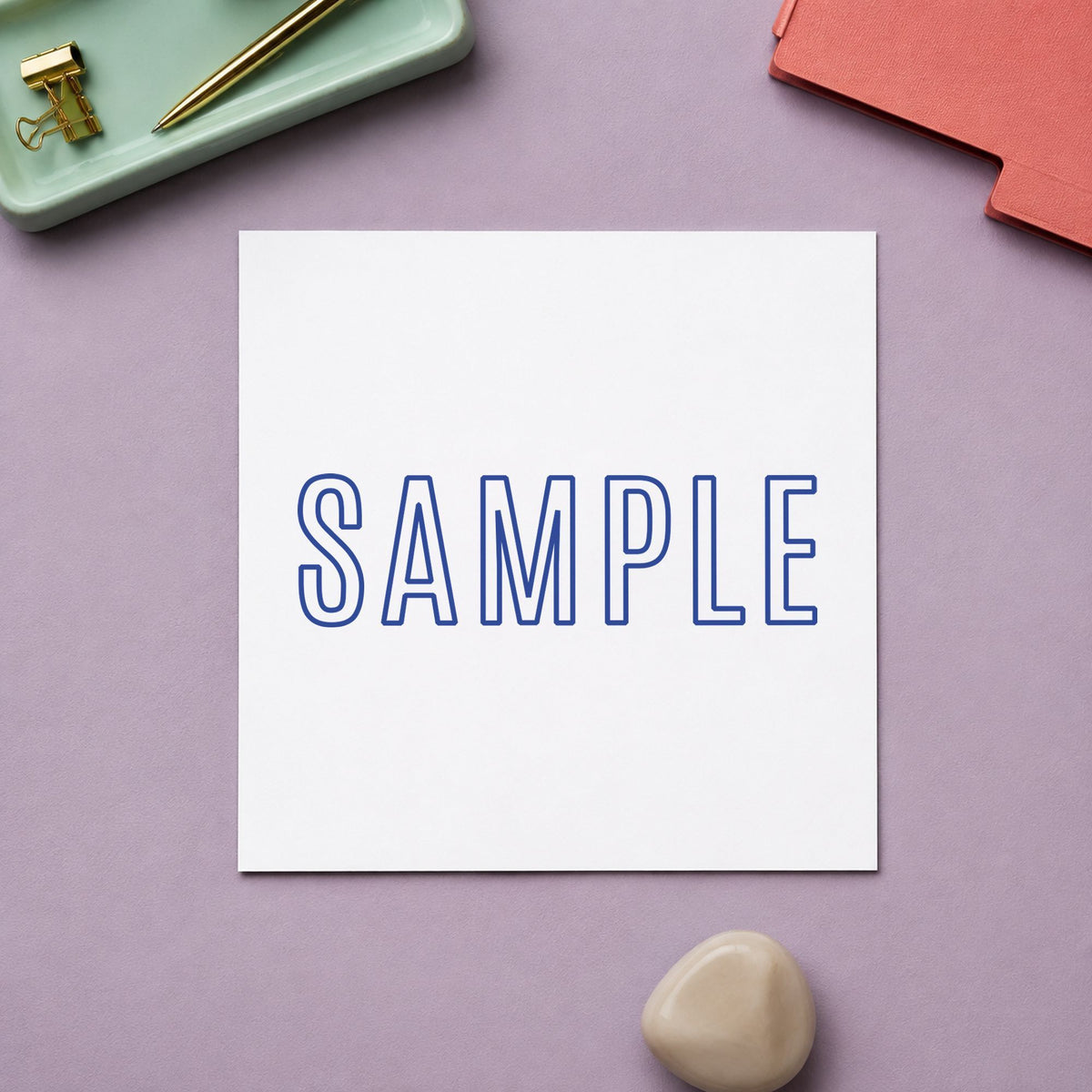 "Sample" Xstamper pre-inked stamp beside its rectangle imprint