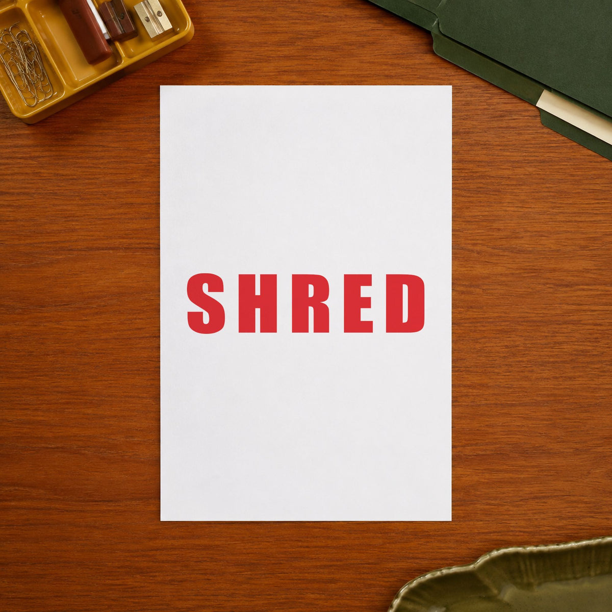 "Shred" stamp pressed on paper, no separate ink pad needed