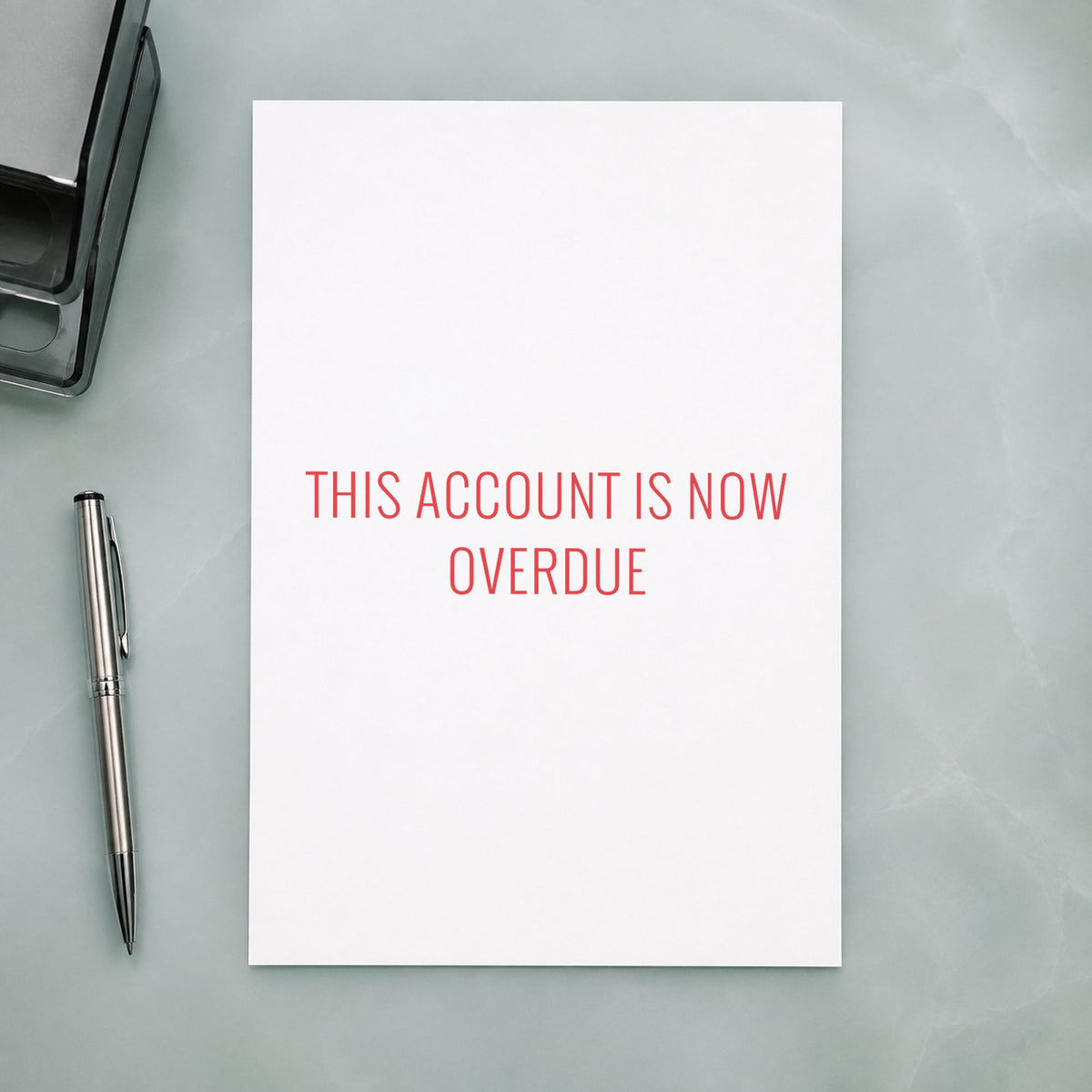 "This account is now overdue" Xstamper stamp in use on paper, 1/2 x 1-5/8 in rectangle imprint