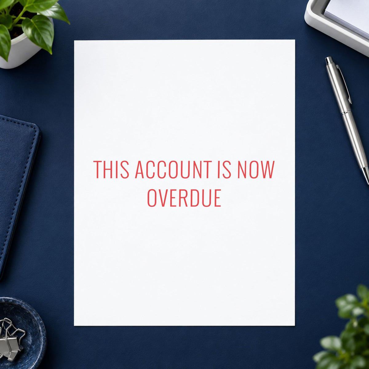 "This account is now overdue" stamp pressed on paper, no separate ink pad needed