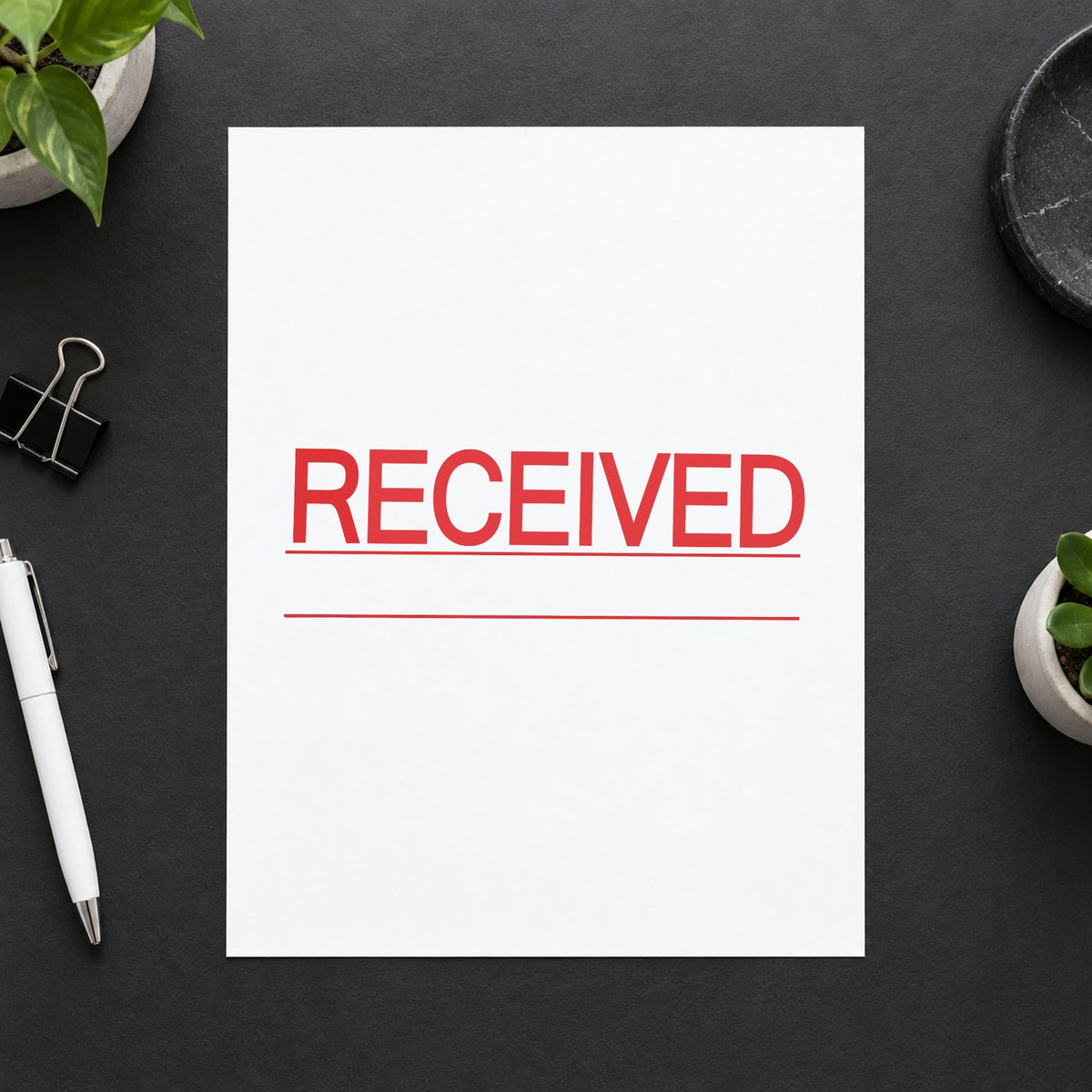 Pre-inked "Received" stamp applied to a document, Approximately 7/8 in tall x 2-3/4 in wide impression