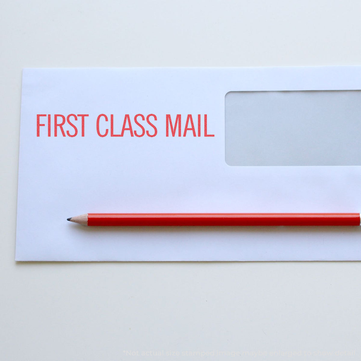 "First class mail" pre-inked imprint on a page, rectangle shape at Approximately 7/8 in tall x 2-3/4 in wide