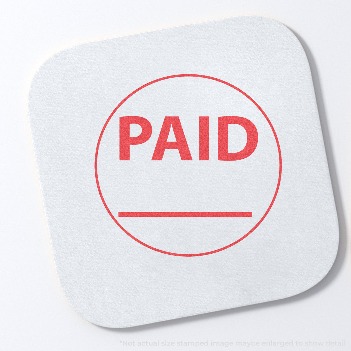 "Paid" stamp and its crisp Approximately 5/8 in diameter impression on paper
