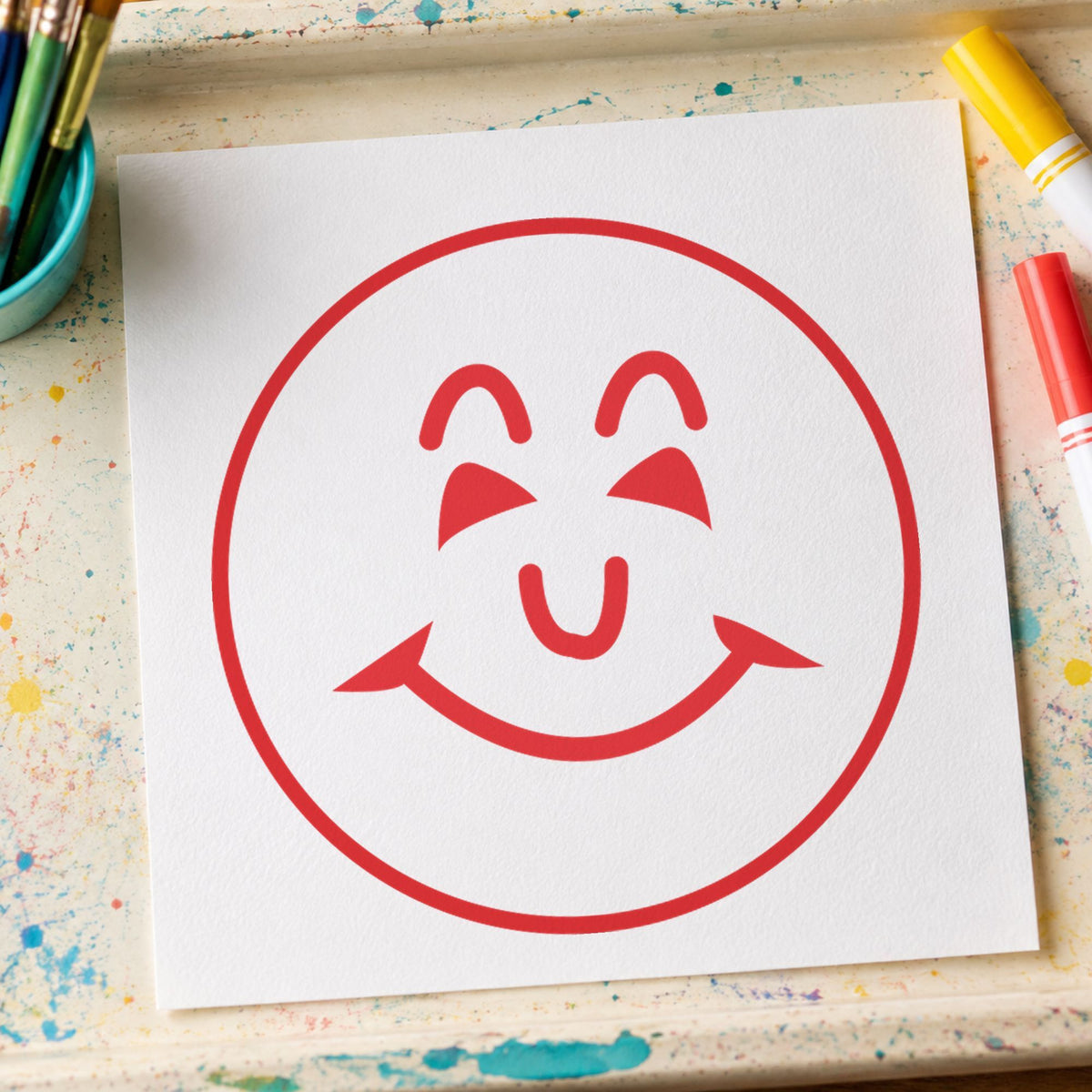 "Smiley face" Xstamper pre-inked stamp beside its round imprint