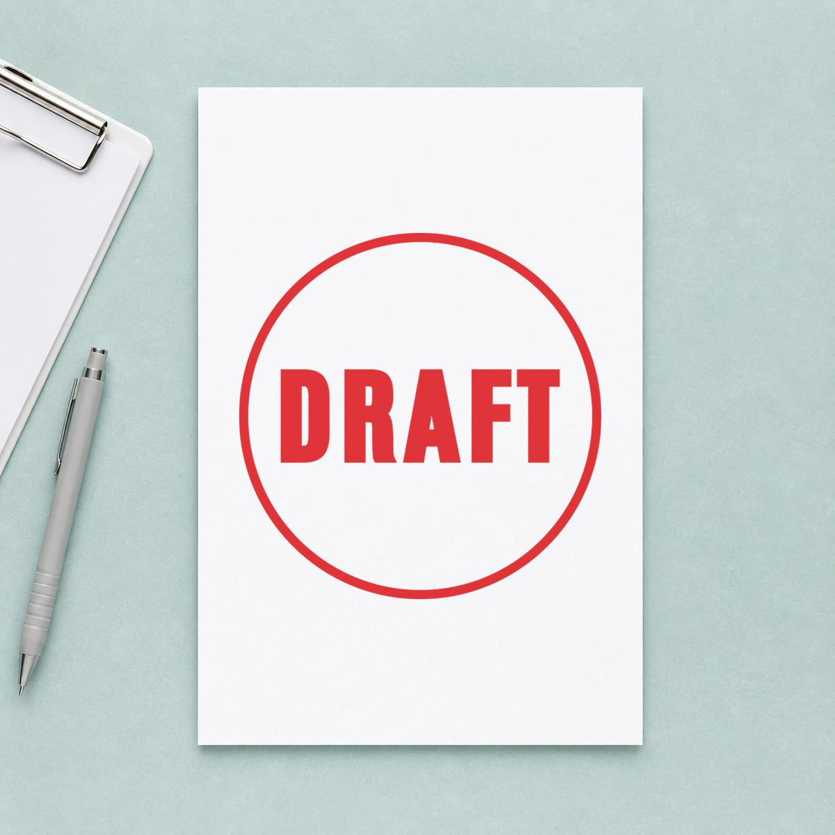 Pre-inked "Draft" stamp marking paperwork in an office setting