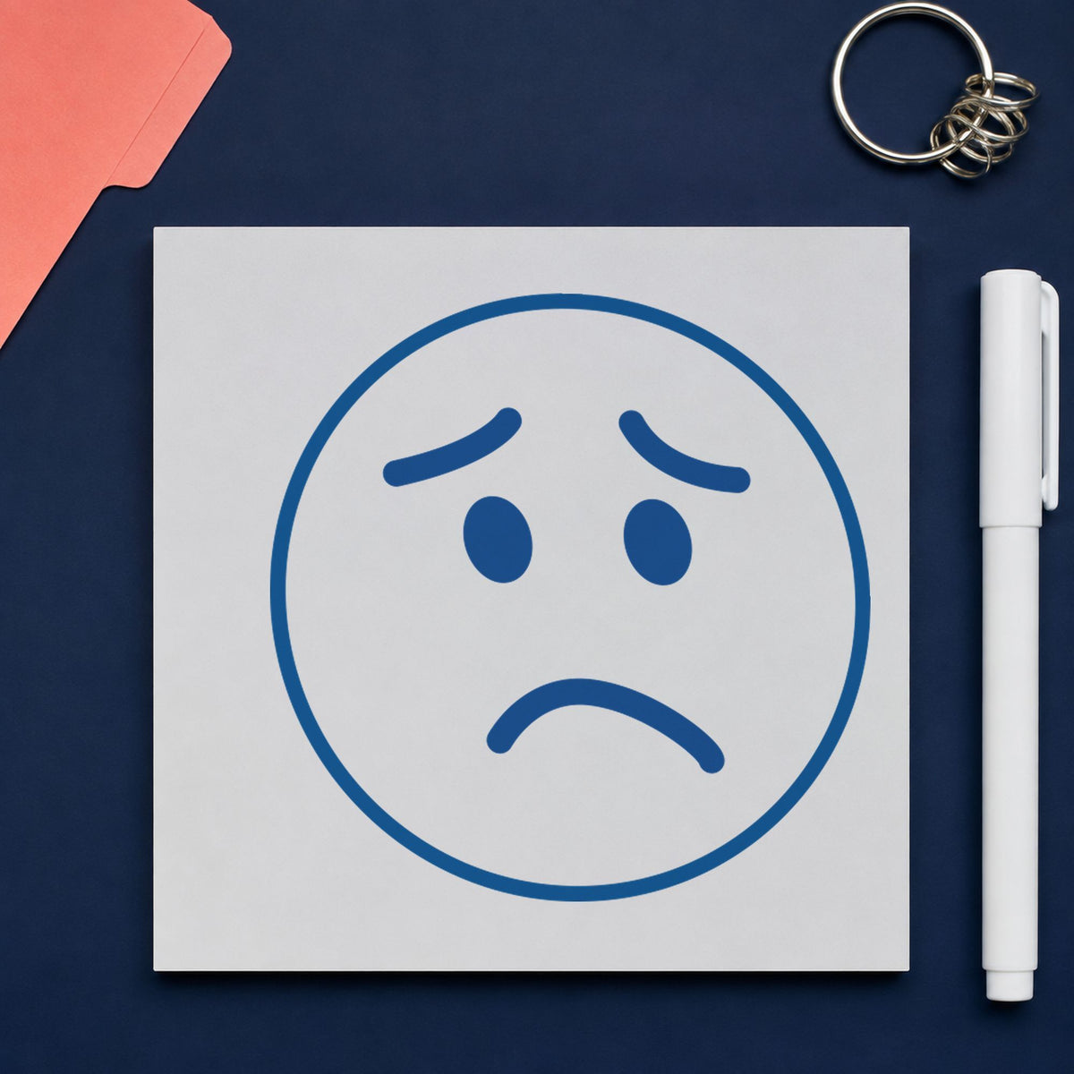 "Frown face" stamp pressed on paper, no separate ink pad needed