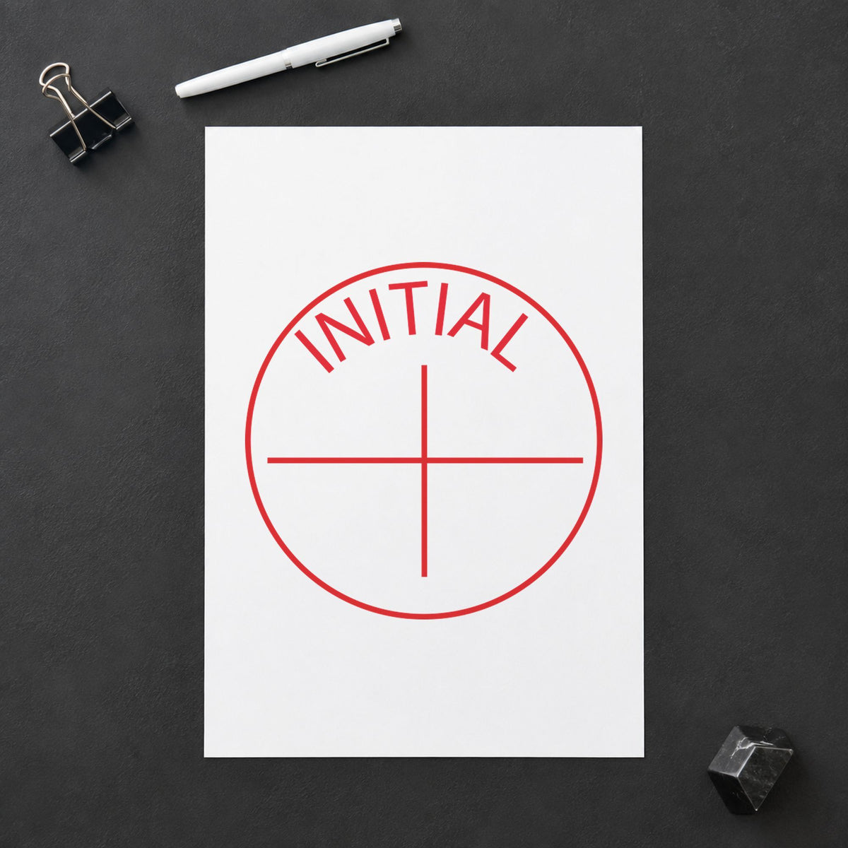 Pre-inked "Initial" stamp marking paperwork in an office setting