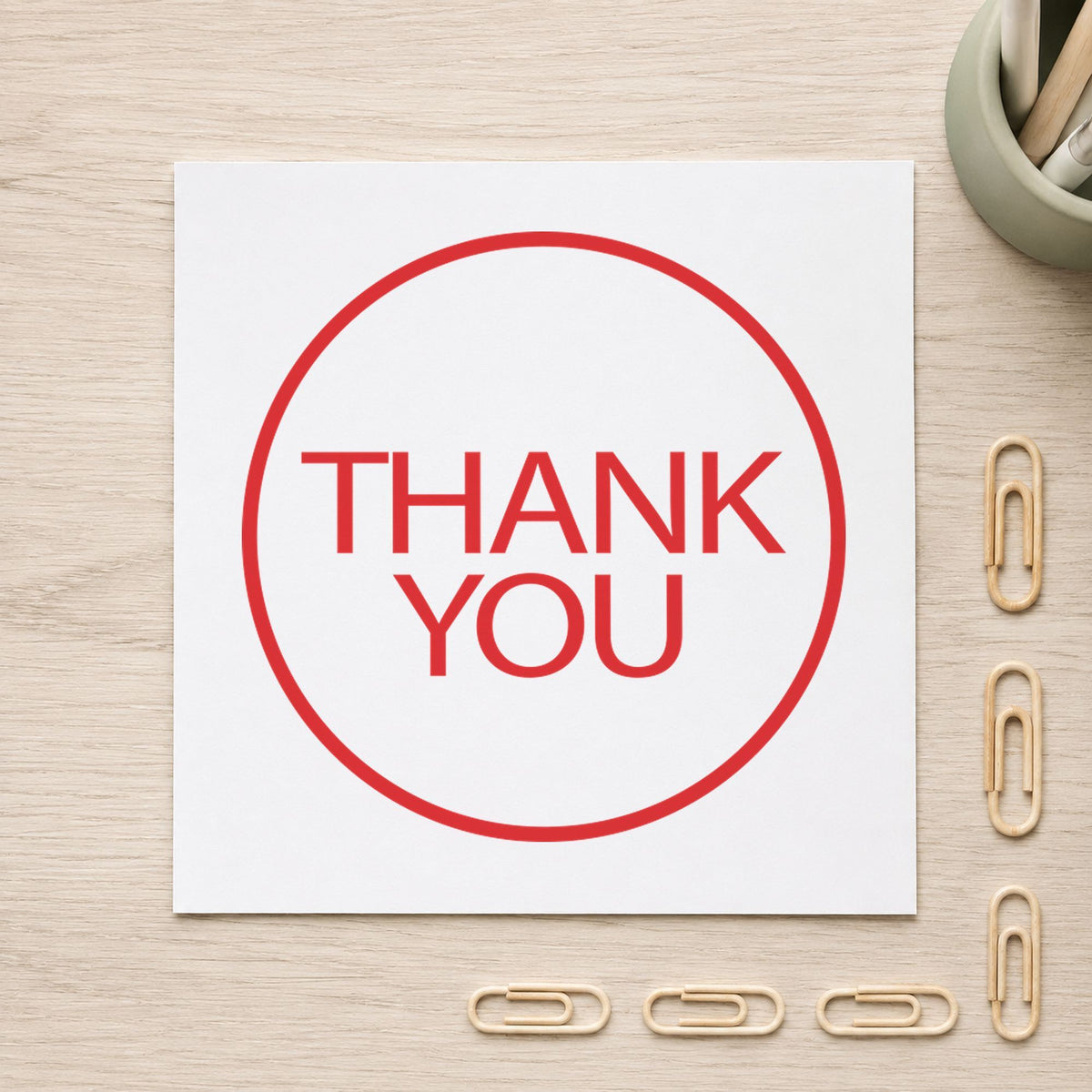 "Thank you" Xstamper pre-inked stamp beside its round imprint