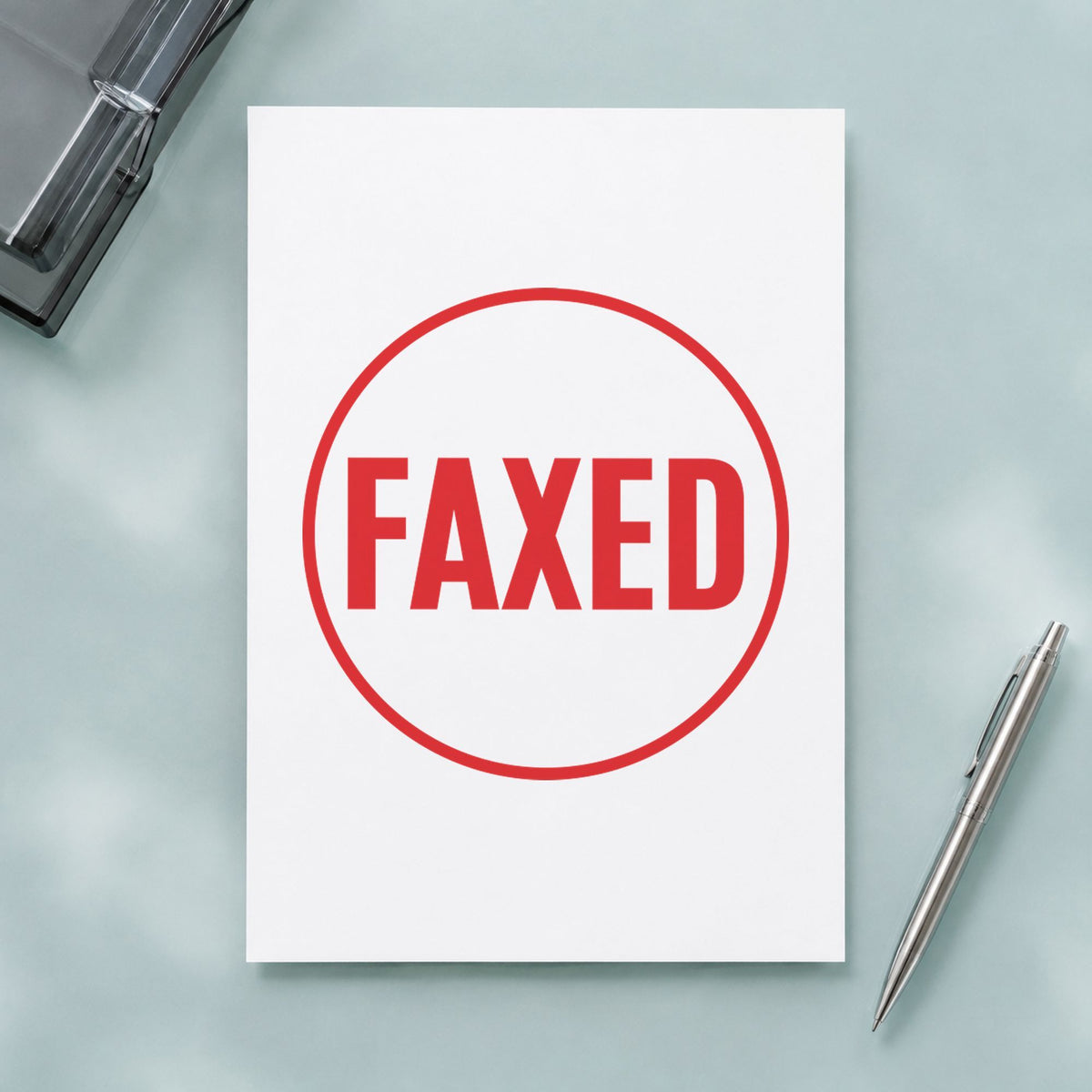 "Faxed" Xstamper stamp in use on paper, Approximately 5/8 in diameter round imprint