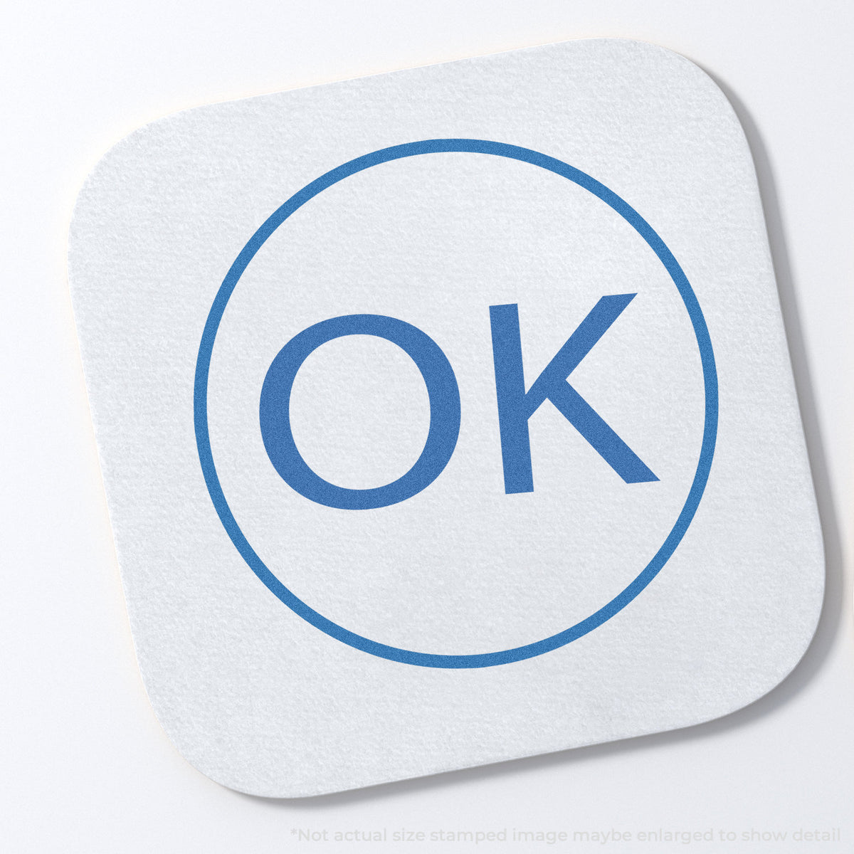 "OK" stamp and its crisp 5/8 in diameter impression on paper