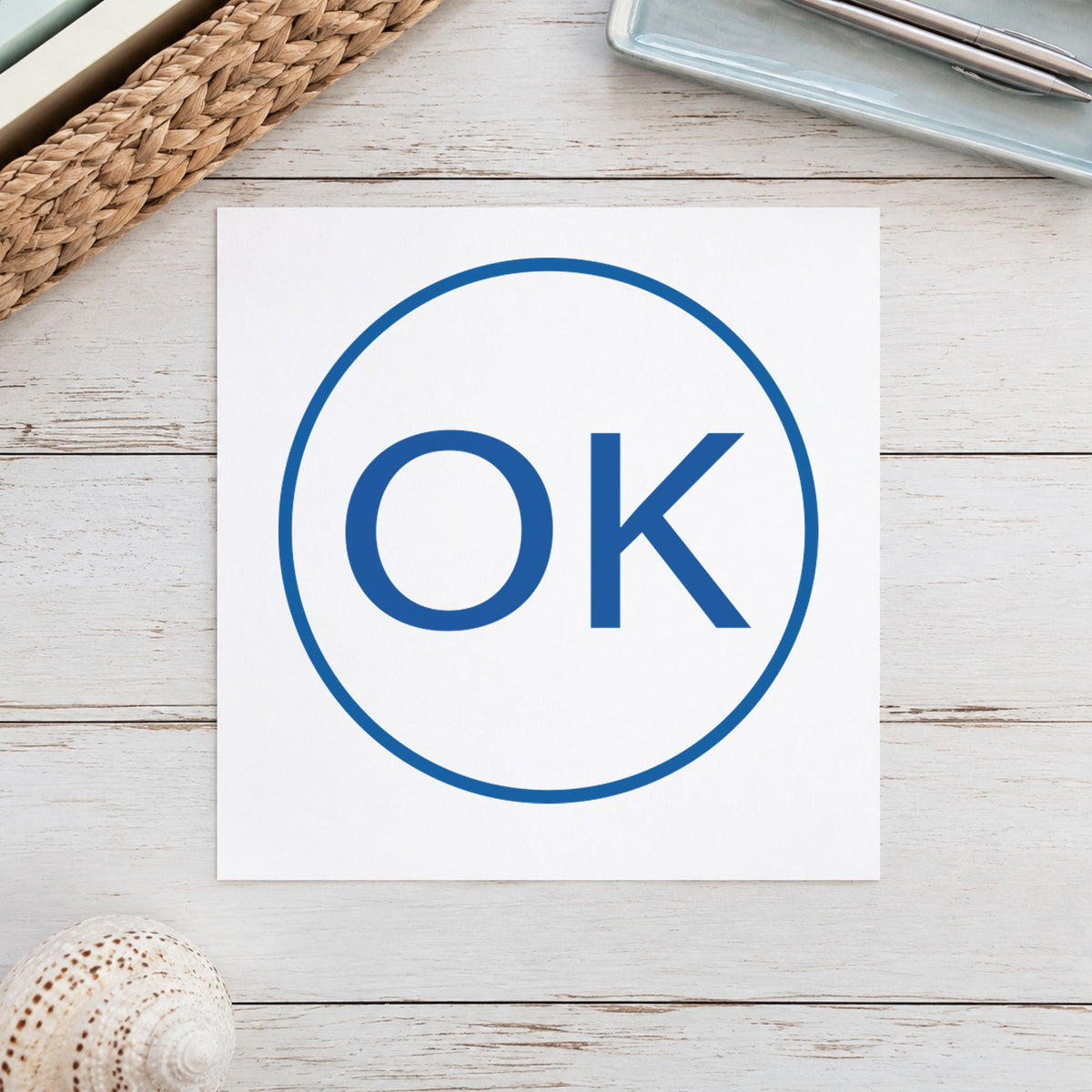 "OK" Xstamper pre-inked stamp beside its round imprint