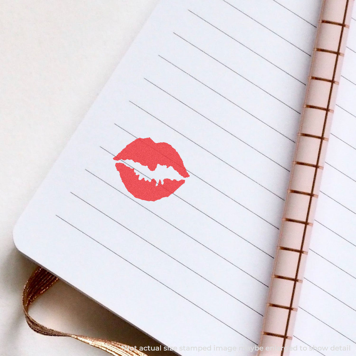 "Kiss" pre-inked imprint on a page, round shape at Approximately 5/8 in diameter